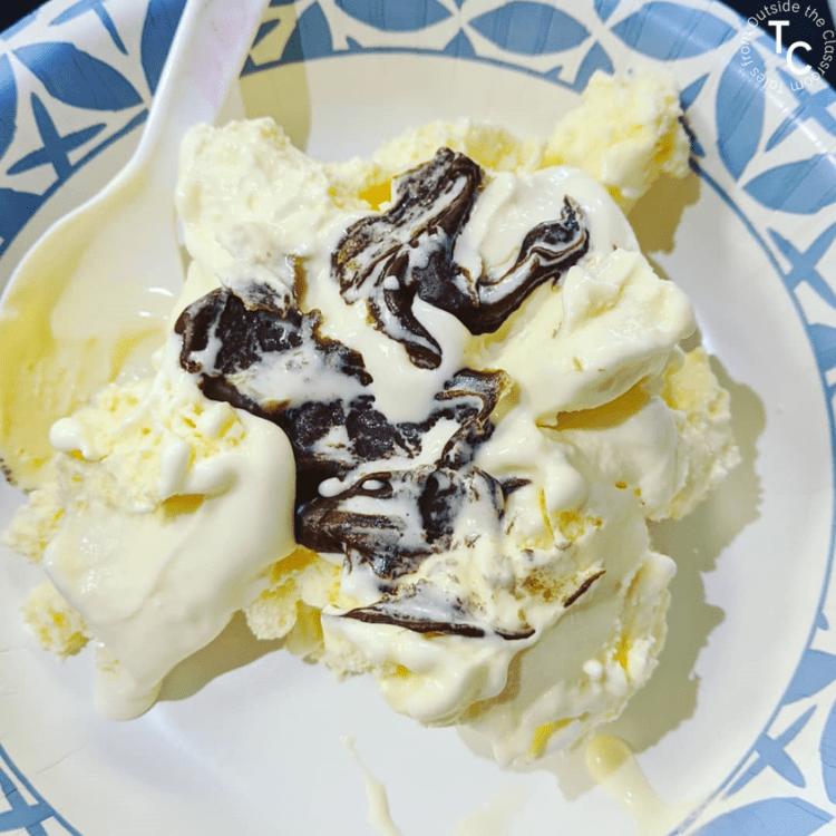 vanilla ice cream in a bowl with Magic Shell hardened on top to demonstrate igneous rocks