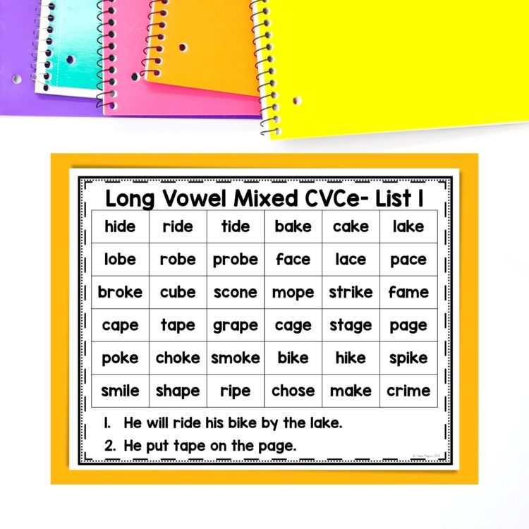 Silent e long vowel blending lines laying atop orange page with spiral notebooks stacked above