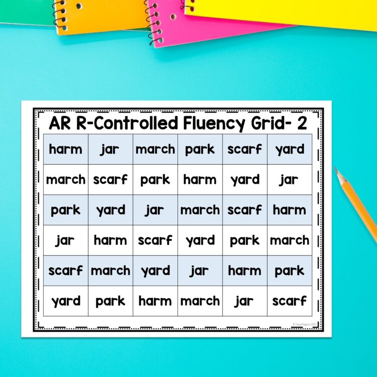 "ar r-controlled fluency grid #2" displayed on a blue background. There is a pencil and brightly colored notebooks laying around it.