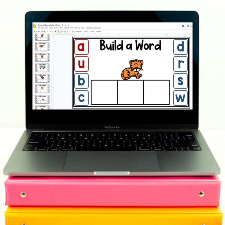 Digital CVC word work activity shown on a Chromebook that's resting atop pastel colored binders
